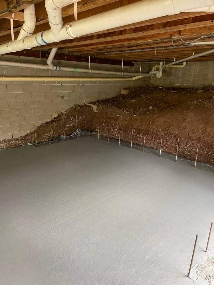 Subfloor concrete slab pour under existing building
