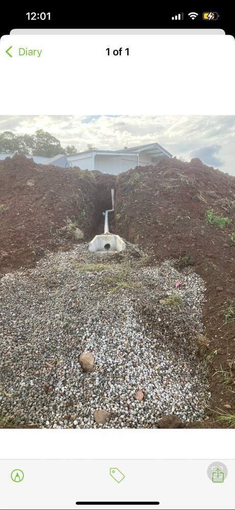 Stormwater drainage trench with headwall and pipe
