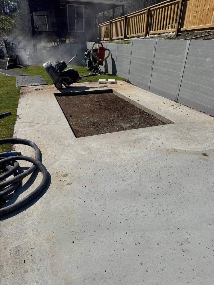 Ride-on concrete saw cutting in action