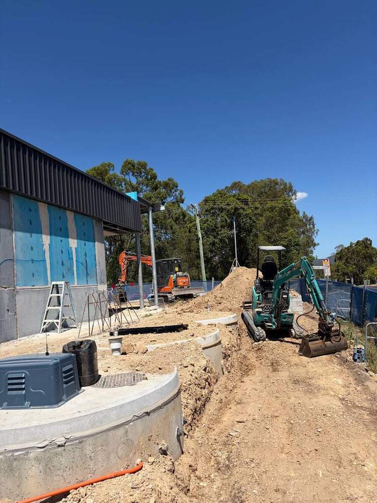Civil site with excavator, precast pits and stormwater trenching