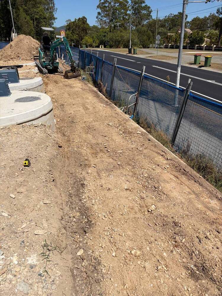 Completed precast concrete pit installation alongside commercial building